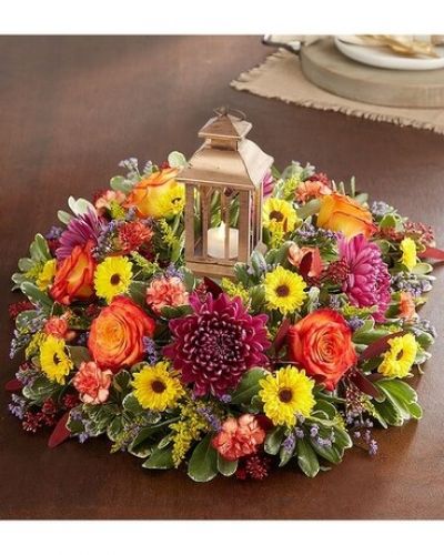 <p>Autumn’s brilliance comes alive in our elegant centerpiece. This classic arrangement is gathered in rich colors and highlighted by our new, antique gold vintage lantern. Crafted in metal with a cathedral-style design, its soft, ambient light (from the included LED tea light) sets the tone for a season of gathering.</p>