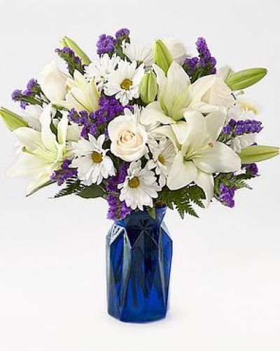 Gift your friends and family the freshest and most beautiful bouquet of lilies, roses and statice. Perfect for complementing any message you want to send, our Beyond Blue Bouquet features a deep blue vase and a gorgeous array of white and purple blooms.

STANDARD
C Quantity	Color	Description
3	Ivory	50 cm Standard Rose - Escimo
2	White	LA Hybrid Lily
5	White	Daisy Pom
3	Purple	Filler - Sinuata Statice
3	Green	Green - Leather Leaf

DELUXE

C Quantity	Color	Description
5	Ivory	50 cm Standard Rose - Escimo
3	White	LA Hybrid Lily
5	White	Daisy Pom
4	Purple	Filler - Sinuata Statice
3	Green	Green - Leather Leaf

PREMIUM

C Quantity	Color	Description
6	Ivory	50 cm Standard Rose - Escimo
4	White	LA Hybrid Lily
5	White	Daisy Pom
4	Purple	Filler - Sinuata Statice
3	Green	Green - Leather Leaf