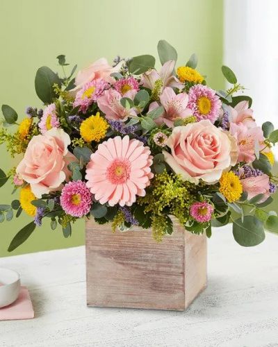 <p>Spring is a time to refresh and reach out. Our spring bouquet celebrates that sentiment. Soft pink and yellow blooms are loosely gathered with lush greenery for style and texture. Designed in our rustic, grey-washed wooden cube, it’s a gift that delivers on your feelings in the most beautiful way.</p>