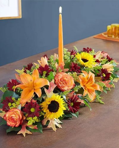 <p>The rich beauty of the European countryside comes alive in our best-selling fall centerpiece. Crafted by our artisan florists, it’s filled with a gathering of fresh-picked blooms in brilliant colors and finished with an orange candle to warm hearts and homes.</p>