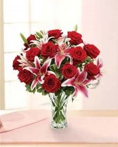 <p>Conjure classic romance with this blossoming bouquet of long-stem red roses, lilies and pittosporum beautifully hand-arranged in an heirloom crystal vase.</p>