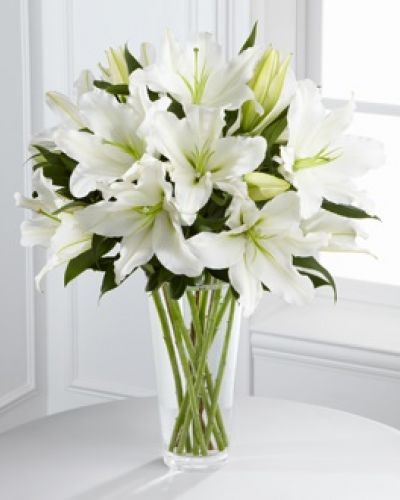 The FTD® Light In Your Honor™ Bouquet is a beautifully bright arrangement bursting with elegant fragrance to convey your deepest sympathies for the loss of their loved one. A stunning bouquet of gorgeous Oriental lilies are accented with lush greens and seated in a clear glass vase to create a bouquet that is serenely sophisticated, offering comfort and peace in their time of need.